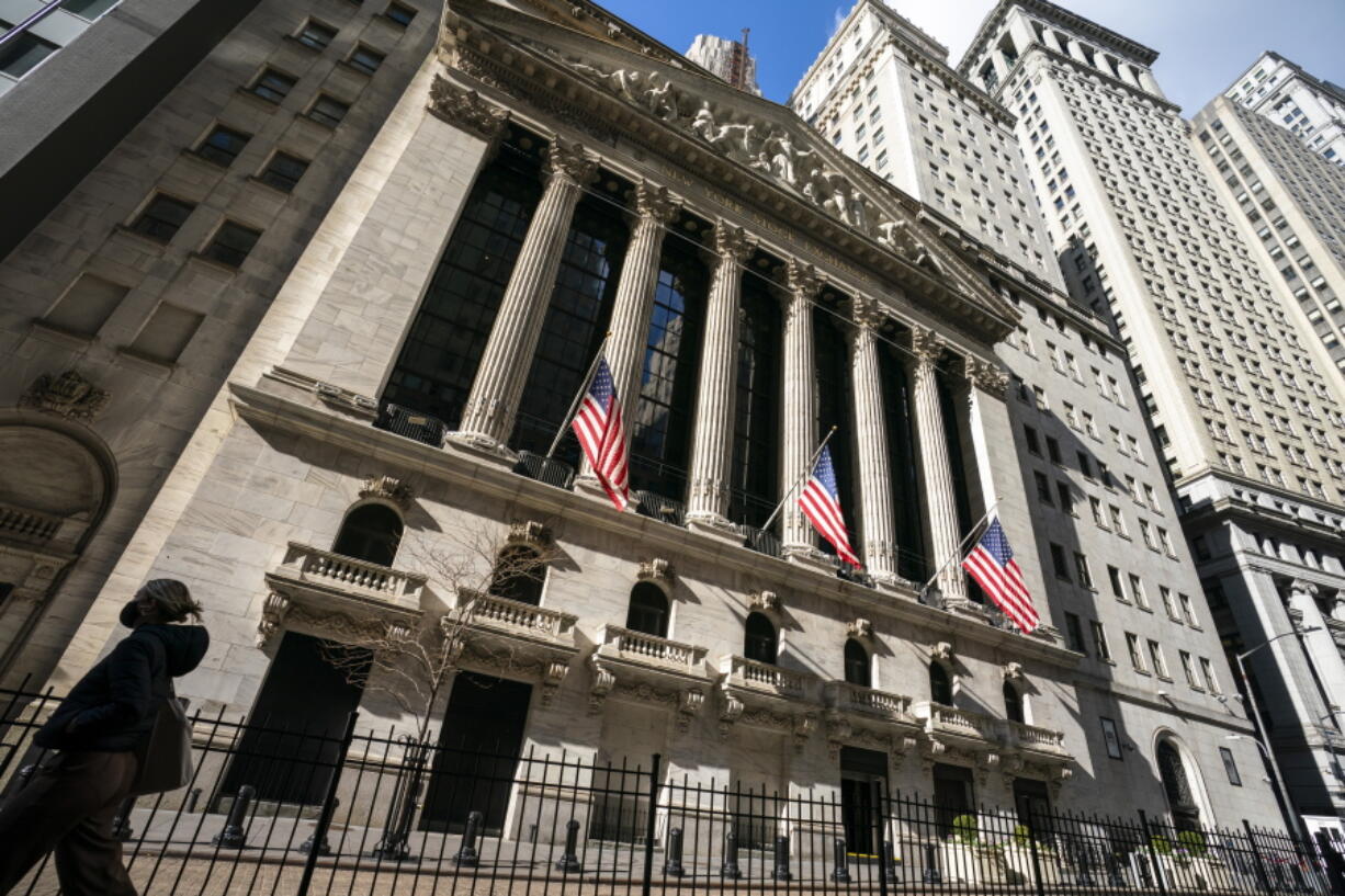 A pedestrian walks past the New York Stock Exchange, Monday, Jan. 24, 2022, in New York.  Stocks are opening sharply lower again on Wall Street Tuesday, Jan. 25, 2022, a day after a wild roller-coaster ride that erased an intraday plunge.