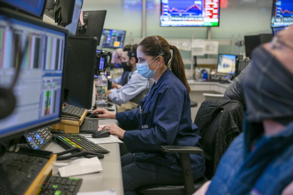 Traders work on the New York Stock Exchange floor in New York, Tuesday, Jan. 25, 2022. Stocks are closing lower on Wall Street Tuesday after another volatile day of trading. Technology companies like Microsoft were again the biggest drag on the market.