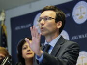 FILE - Washington Attorney General Bob Ferguson talks to reporters, Monday, Aug. 26, 2019, during a news conference in Seattle. In a 5-4 decision Thursday, Jan. 20, 2022, the Washington Supreme Court upheld an $18 million campaign finance penalty against the Consumer Brands Association, formerly known as the Grocery Manufacturers Association. Ferguson sued the group in 2013, alleging that it spent $11 million to oppose a ballot initiative without registering as a political committee or disclosing the source of the money. (AP Photo/Ted S.