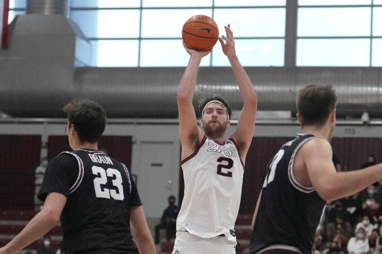 Gonzaga forward Drew Timme (2) takes a 3-point shot between Santa Clara forward Parker Braun (23) and forward Josip Vrankic, right, during the second half of an NCAA college basketball game Saturday, Jan. 15, 2022, in Santa Clara, Calif.