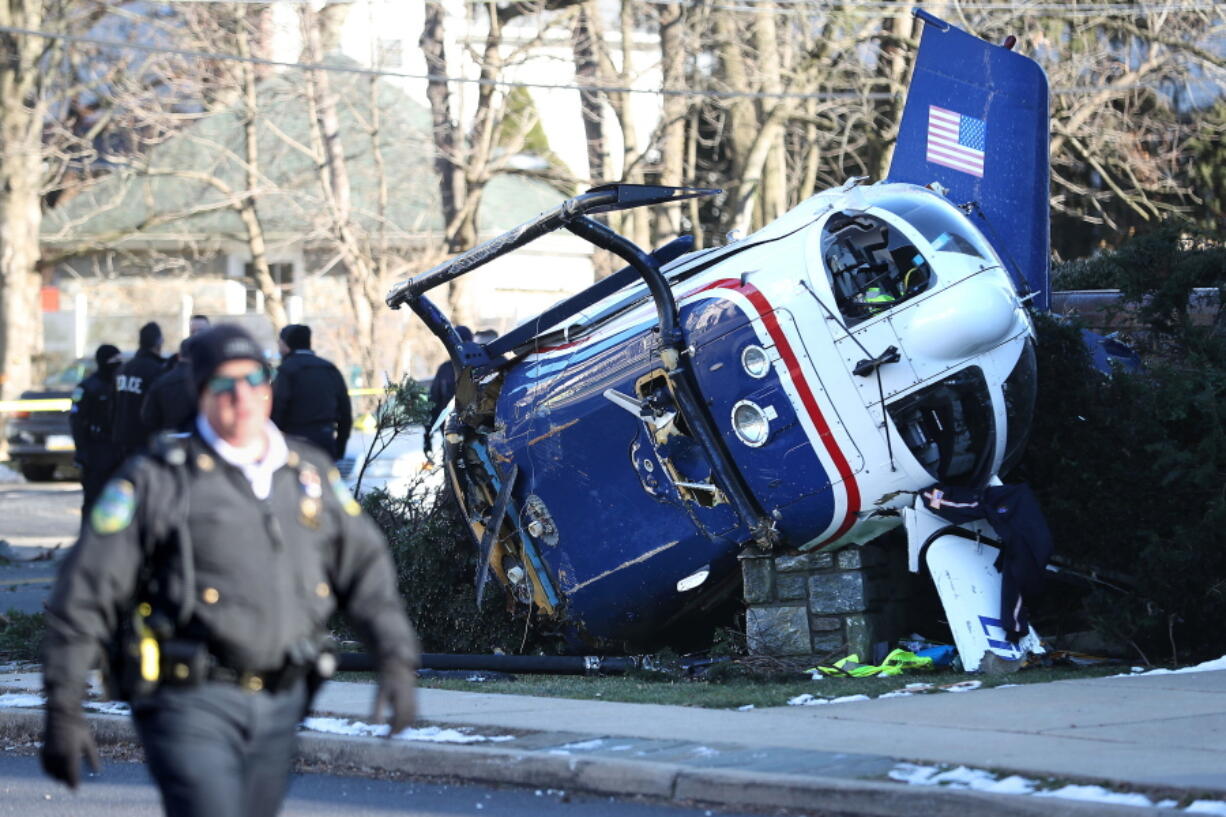 A medical helicopter rests next to the Drexel Hill United Methodist Church after it crashed in the Drexel Hill section of Upper Darby Township in Delaware County, Pa., on Tuesday, Jan. 11, 2022.