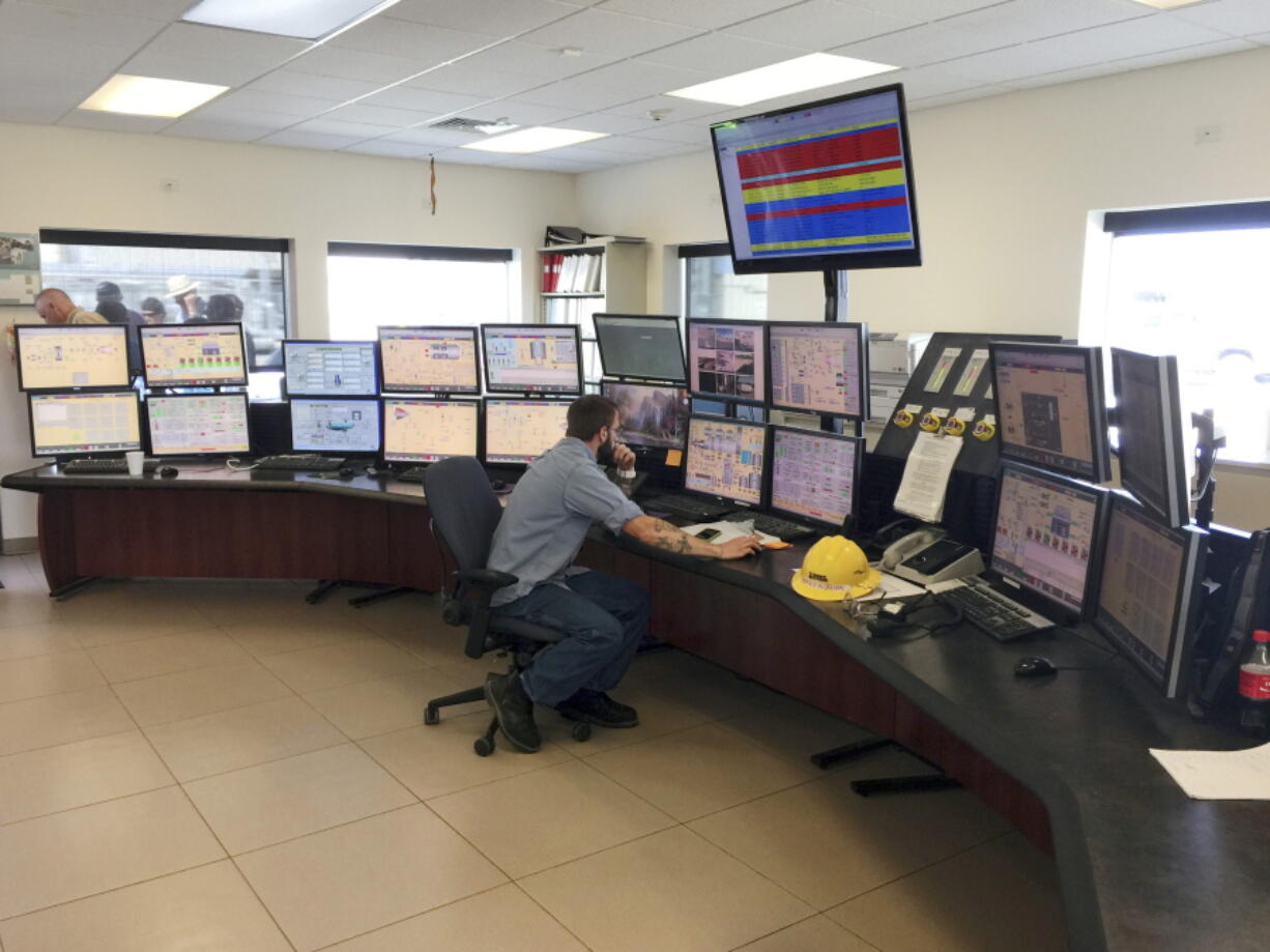 FILE - This July 16, 2015 file photo shows employee Michael Kurian at Idaho Power Company's Langley Gulch Power Plant in New Plymouth, Idaho. Idaho Power has submitted a 20-year plan to state regulators that phases out coal-fired power plants by 2028 as part of an effort to provide only clean energy by 2045. The public utility in a news release, Tuesday, Jan. 4, 2022, said it submitted its Integrated Resources Plan to the Idaho Public Utilities Commission.