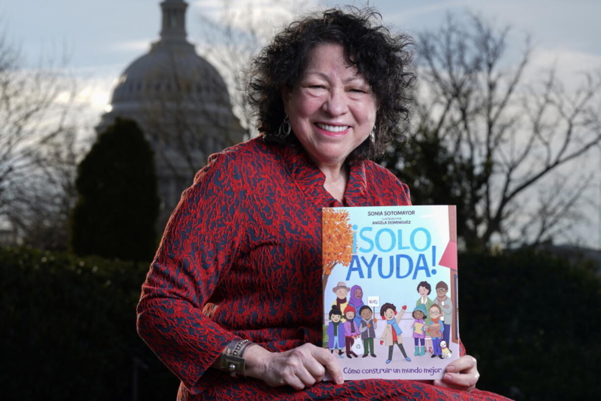 Supreme Court Associate Justice Sonia Sotomayor holds her new children's book "Just Help!" on Jan. 19 on Capitol Hill in Washington.