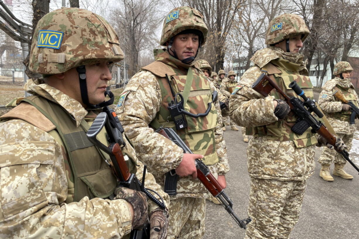 In this handout photo released by Russian Defense Ministry Press Service, Collective Security Treaty Organization peacekeepers guard an area in Almaty, Kazakhstan, Tuesday, Jan. 11, 2022. The president of Kazakhstan has announced that a Russia-led security alliance will start pulling out its troops from the country in two days after completing its mission. The mostly Russian troops were deployed to Kazakhstan last week by the Collective Security Treaty Organization, an alliance of six former Soviet states, at the president's request amid unprecedented public unrest.