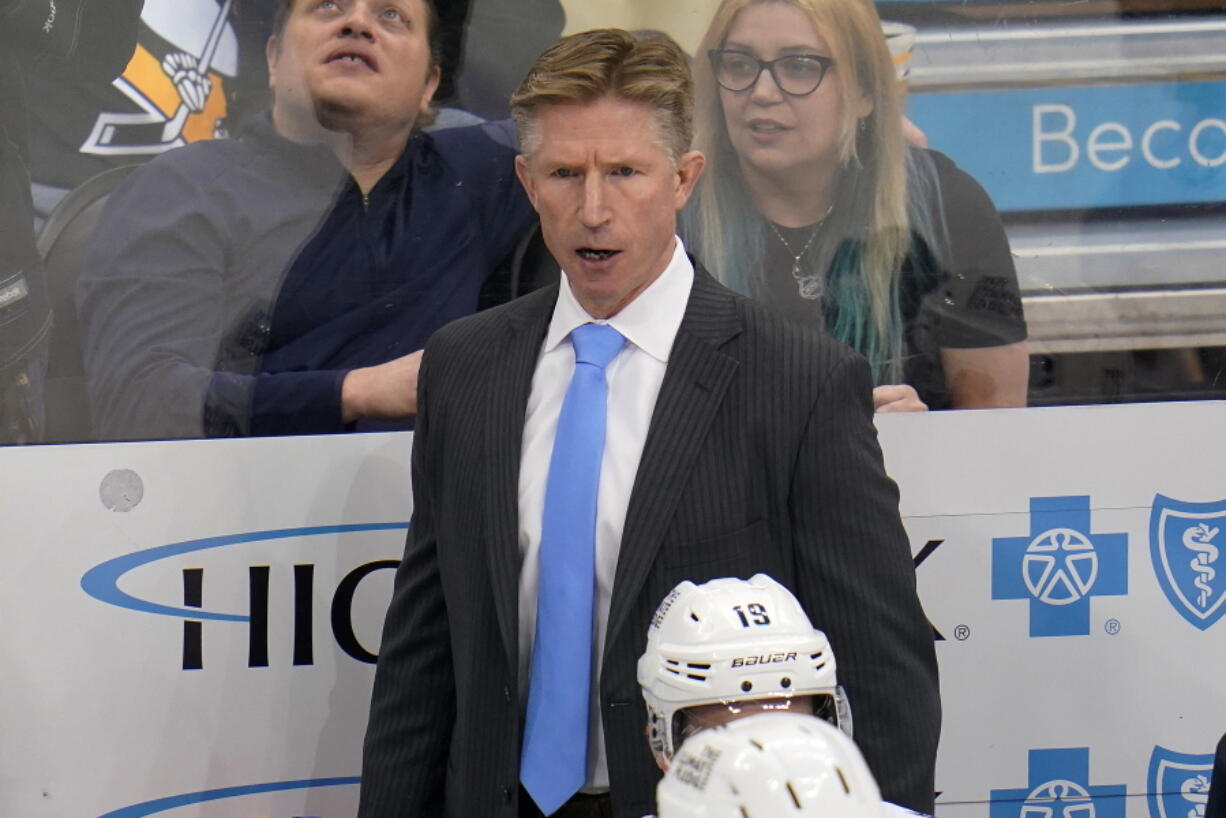 Seattle Kraken head coach Dave Hakstol stands behind his bench during the third period of an NHL hockey game against the Pittsburgh Penguins in Pittsburgh, Thursday, Jan. 27, 2022. The Kraken won in overtime 2-1. (AP Photo/Gene J.