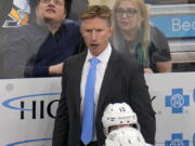 Seattle Kraken head coach Dave Hakstol stands behind his bench during the third period of an NHL hockey game against the Pittsburgh Penguins in Pittsburgh, Thursday, Jan. 27, 2022. The Kraken won in overtime 2-1. (AP Photo/Gene J.