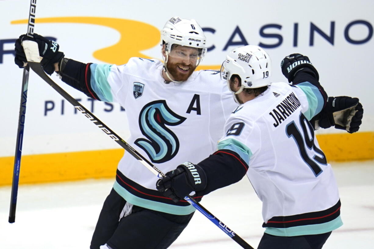 Seattle Kraken's Adam Larsson (6) celebrates with Calle Jarnkrok after scoring the game-winning goal in the overtime period of an NHL hockey game against the Pittsburgh Penguins in Pittsburgh, Thursday, Jan. 27, 2022. The Kraken won in overtime 2-1. (AP Photo/Gene J.