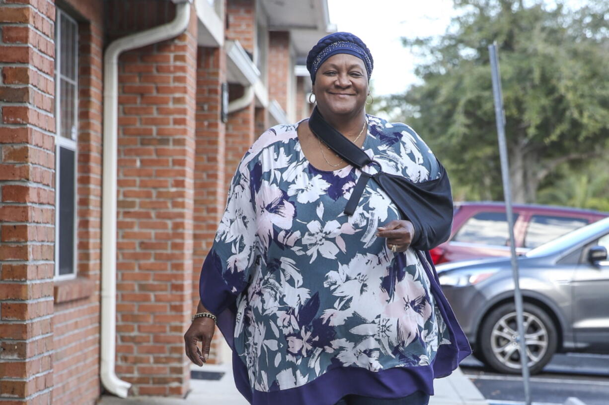 Vanessa Akinniyi poses front of her doctor's office in Jacksonville, Fla., Thursday, Jan. 13, 2022. Akinniyi was stuck in denial about diabetes until a care manager from her health insurer coaxed her out. The nurse fed Akinniyi information about her condition and talked about potential problems she could run into like vision loss.