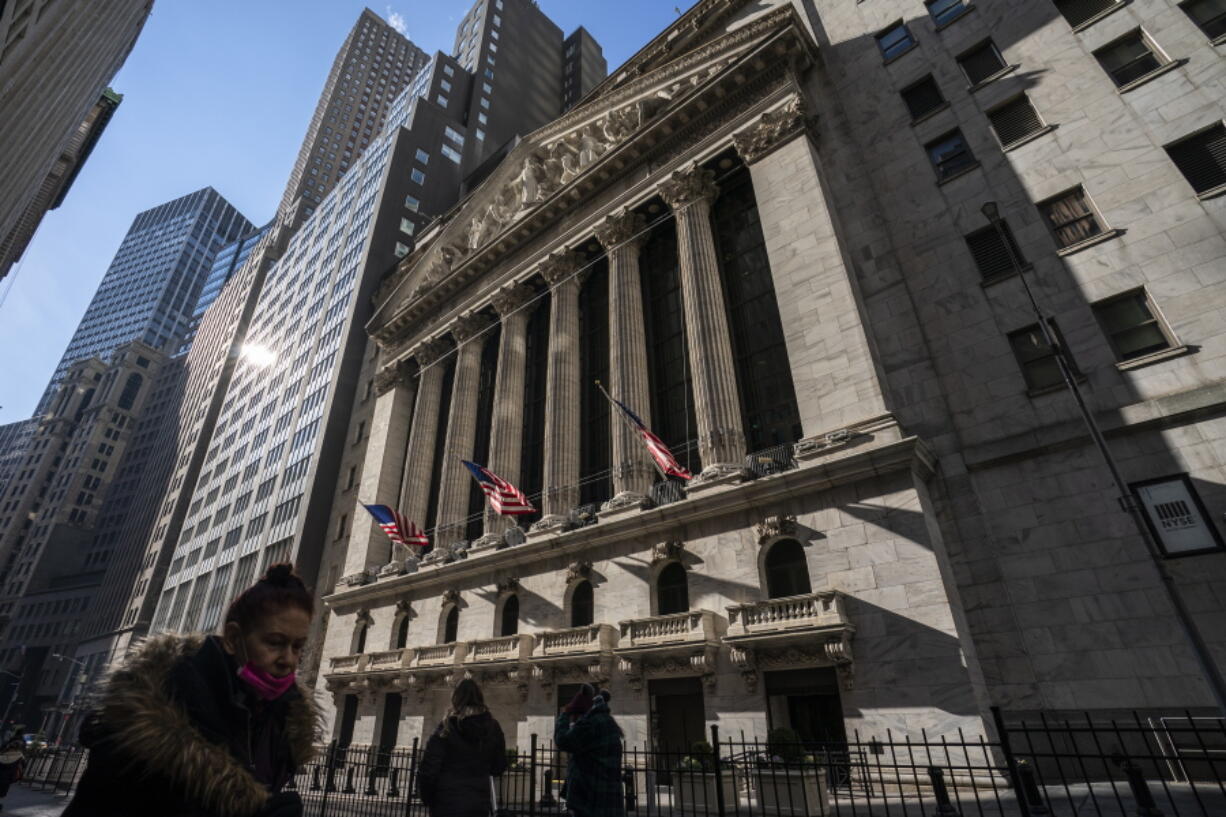 Pedestrians walk past the New York Stock Exchange, Jan. 24, 2022, in New York. Stocks are off to a weak start on Wall Street Monday, Jan. 31, 2022 keeping the S&P 500 index on track to end January with its worst monthly loss since March 2020, when pandemic shutdowns started to seize up the economy.