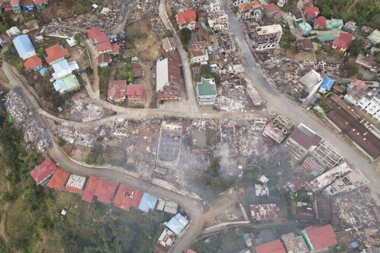 In this aerial photo, fires destroy numerous buildings in the town of Thantlang in Chin State in northwest Myanmar on Dec. 4. More than 580 buildings in the town have been burned since September, according to satellite image analysis by Maxar Technologies.