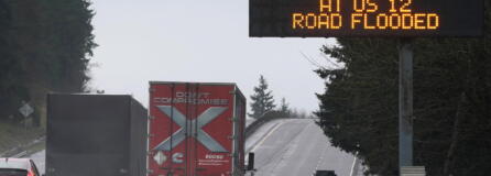 A sign warns drivers of a section of Interstate 5 that is closed ahead due to rising flood water from the Chehalis River, Friday, Jan. 7, 2022, near Rochester, Wash. Rain and snow continued to fall across the Pacific Northwest Friday, causing flooding and concerns about avalanche danger in the mountains. (AP Photo/Ted S.