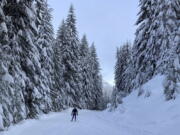 A cross country skier glides along the freshly groomed trails at Cabin Creek Sno Park near Easton, Washington on Dec. 19, 2021. When COVID-19 hit in the winter of 2020, many escaped cabin fever by hitting the ski trails and Nordic skis quickly became the new toilet paper - they were hard to find and sold out in stores. The ski boom has continued as the pandemic makes winter outdoor recreation appealing, but climate change means its future is uncertain.