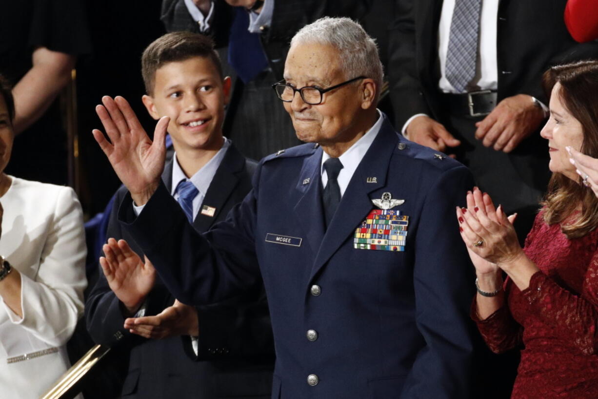 FILE - Tuskegee airman Charles McGee and his great grandson Iain Lanphier react as President Donald Trump delivers his State of the Union address to a joint session of Congress on Capitol Hill in Washington, Tuesday, Feb. 4, 2020. McGee, one of the last surviving Tuskegee Airmen who flew 409 fighter combat missions over three wars, died Sunday, Jan. 16, 2022. He was 102.