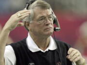 FILE - Atlanta Falcons coach Dan Reeves adjusts his headset at the start of play against the Detroit Lions at the Georgia Dome in Atlanta Sunday, Dec. 22, 2002.  Reeves, who won a Super Bowl as a player with the Dallas Cowboys but was best known for a long coaching career highlighted by four more appearances in the title game with the Denver Broncos and Atlanta Falcons, died Saturday, Jan. 1, 2022.