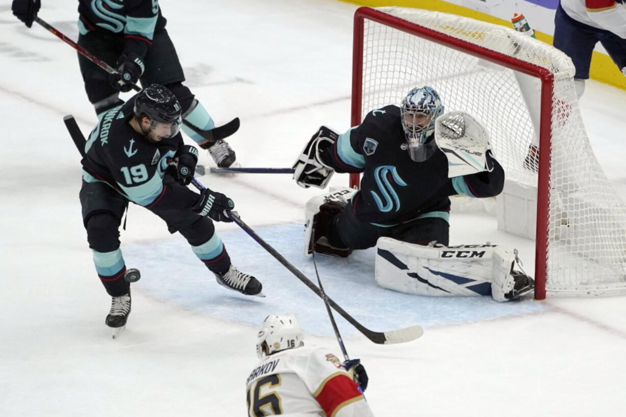 Seattle Kraken goaltender Philipp Grubauer (31) looks on as Kraken center Calle Jarnkrok (19) clears the puck during the second period of an NHL hockey game against the Florida Panthers, Sunday, Jan. 23, 2022, in Seattle. (AP Photo/Ted S.