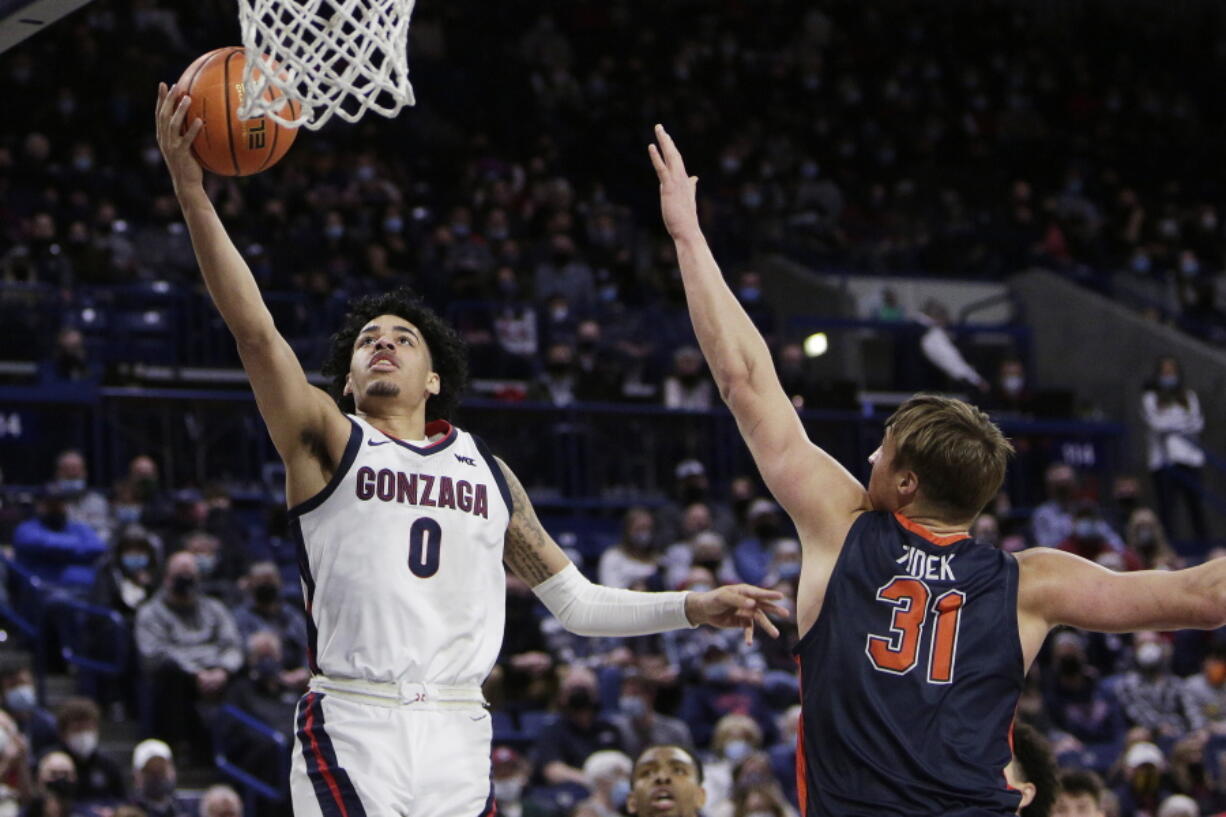 Gonzaga guard Julian Strawther (0) shoots next to Pepperdine forward Jan Zidek (31) during the second half of an NCAA college basketball game Saturday, Jan. 8, 2022, in Spokane, Wash. Gonzaga won 117-83.