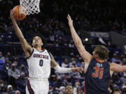 Gonzaga guard Julian Strawther (0) shoots next to Pepperdine forward Jan Zidek (31) during the second half of an NCAA college basketball game Saturday, Jan. 8, 2022, in Spokane, Wash. Gonzaga won 117-83.