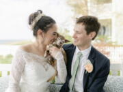 Caitlin Koska, left, and Michael White play with their 14-year-old rescue dog, Luna, at their wedding May 1 in St. Joseph, Mich. The couple adopted their pet after her owner died through Tyson's Place Animal Rescue, a specialized organization focused on helping the terminally ill and seniors headed to residential care.