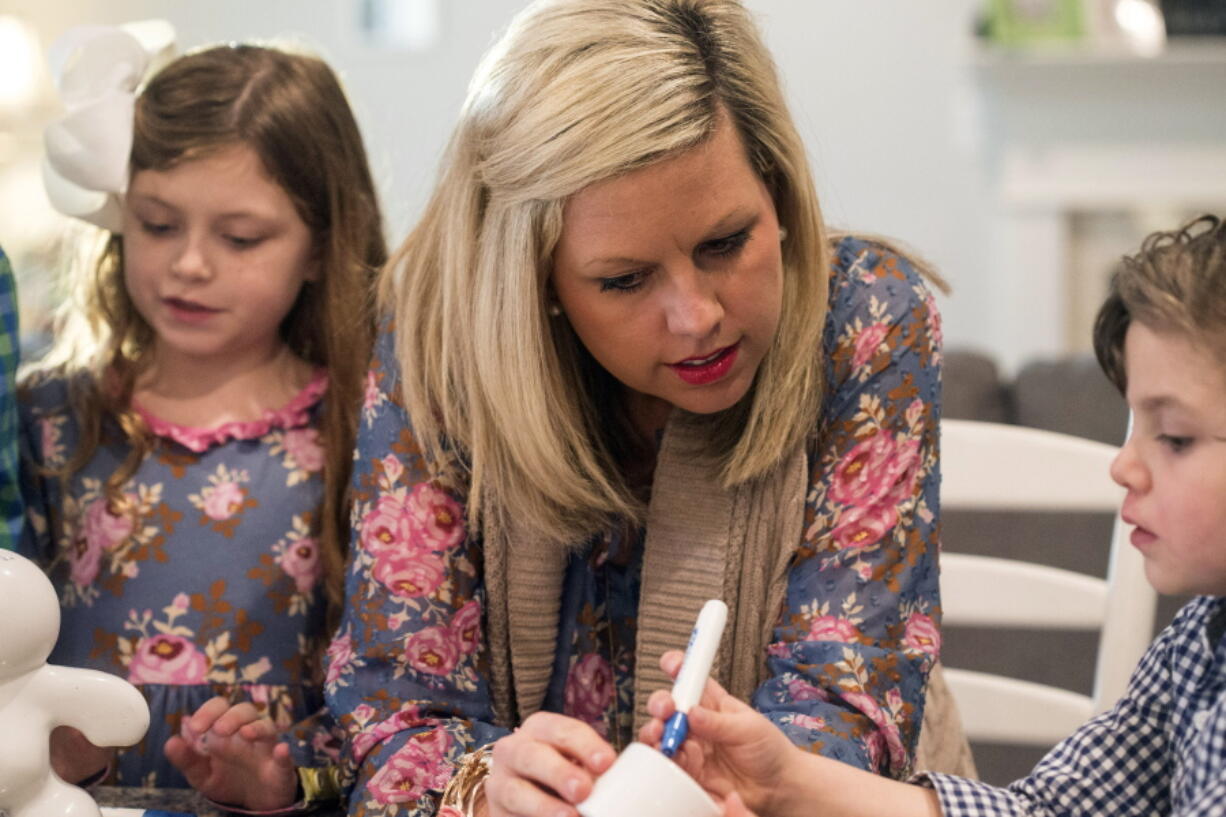 Bekah Bischoff plays Pictionary Man with her children, Henry and Ady, on Feb. 8, 2018 in Louisville, Ky. Bischoff, who developed preeclampsia during two pregnancies and now helps other moms who've had the condition, said she was diagnosed late in the third trimester both times. While pregnant with Henry in 2012, she found out she had a very severe type called HELLP Syndrome at 36 weeks. He was delivered that day. She nearly died.