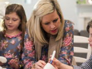 Bekah Bischoff plays Pictionary Man with her children, Henry and Ady, on Feb. 8, 2018 in Louisville, Ky. Bischoff, who developed preeclampsia during two pregnancies and now helps other moms who've had the condition, said she was diagnosed late in the third trimester both times. While pregnant with Henry in 2012, she found out she had a very severe type called HELLP Syndrome at 36 weeks. He was delivered that day. She nearly died.