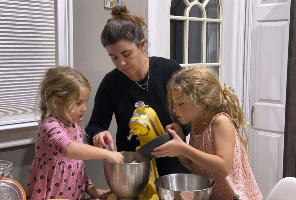 Danielle McWilliams cooks with her daughters Reese, 7, right, and Remi, 4, at their New Jersey home. Along with the usual cupcakes, crispy treats and from-scratch cookies, they make tarallis, an Italian traditional treat.