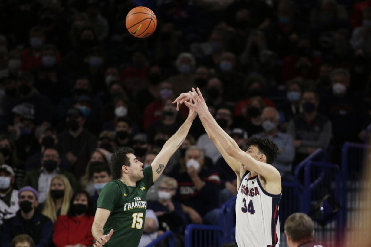 Gonzaga center Chet Holmgren (34) shoots over San Francisco guard Gabe Stefanini (15) during the first half of an NCAA college basketball game, Thursday, Jan. 20, 2022, in Spokane, Wash.