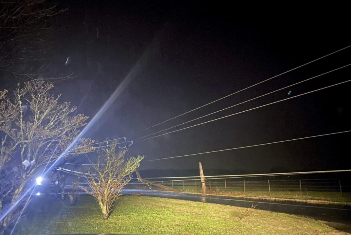 This photo provided by Madison County Sheriff's Office, authorities closed down a road after power lines came down and homes suffered damage early Sunday, Jan. 2, 2022 in Hazel Green, Ala. The storms followed a system earlier Saturday which brought a possible tornado and flooding to parts of Kentucky.