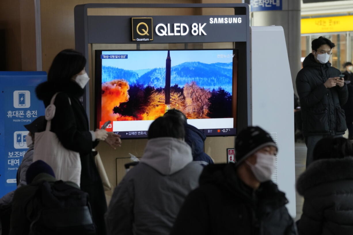 People watch a TV showing an image of North Korea's missile launch during a news program at the Seoul Railway Station in Seoul, South Korea, Monday, Jan. 31, 2022. North Korea confirmed Monday it test-launched an intermediate-range ballistic missile capable of reaching the U.S. territory of Guam, the North's most significant weapon launch in years, as Washington plans to respond to demonstrate it's committed to its allies' security in the region.