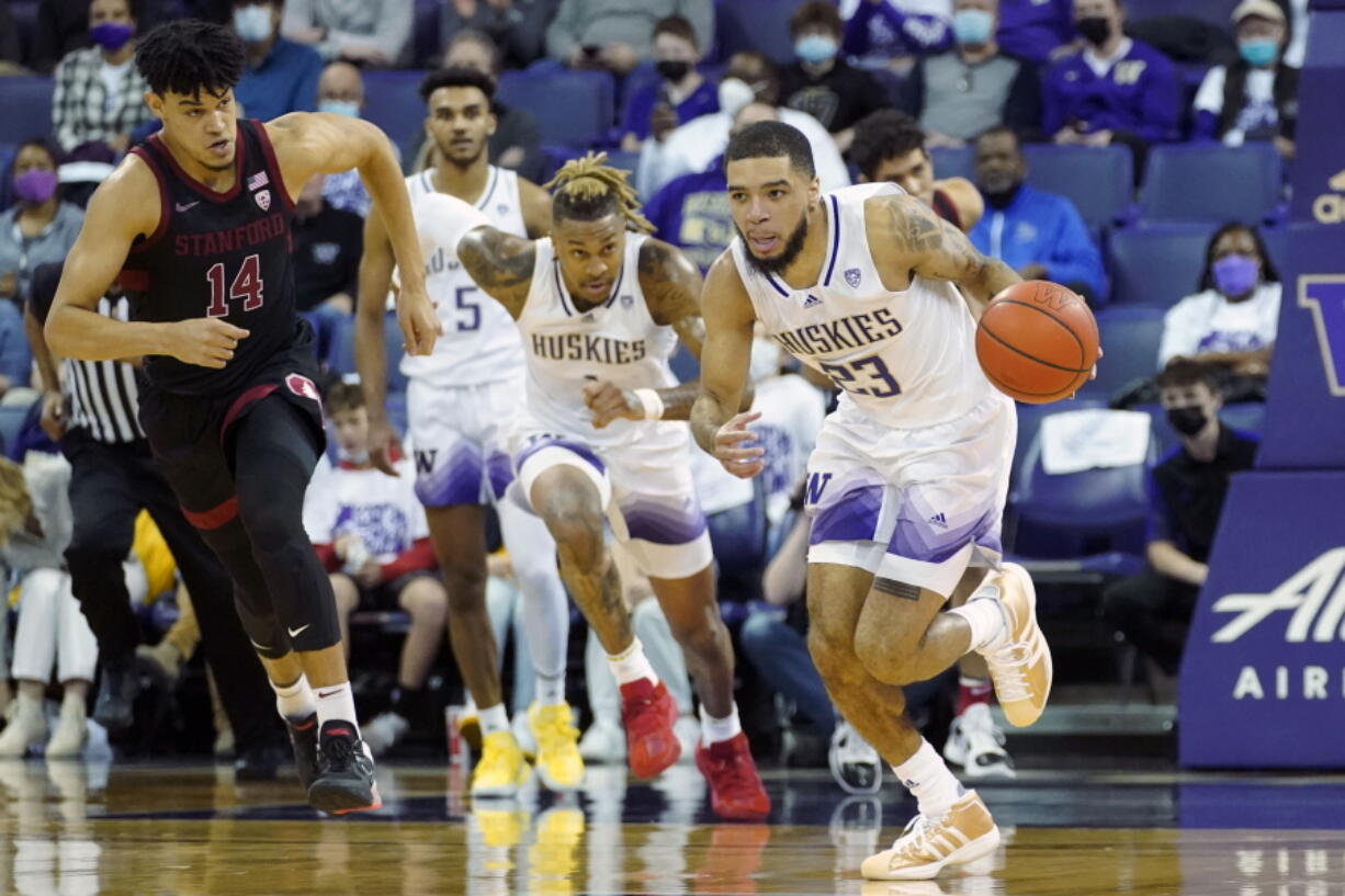 Washington guard Terrell Brown Jr. (23) breaks away after a turnover as Stanford forward Spencer Jones (14) looks on during the first half of an NCAA college basketball game, Saturday, Jan. 15, 2022, in Seattle. (AP Photo/Ted S.