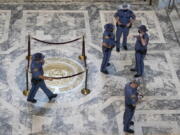 Washington State Patrol troopers stand near the state seal in the rotunda of the Legislative Building, Tuesday, Jan. 11, 2022, before Gov. Jay Inslee's scheduled State of the State address at the Capitol in Olympia, Wash. Due to cautions against COVID-19, Inslee will give the speech in the State Reception Room and it will be shown by streaming video to lawmakers meeting remotely. (AP Photo/Ted S.