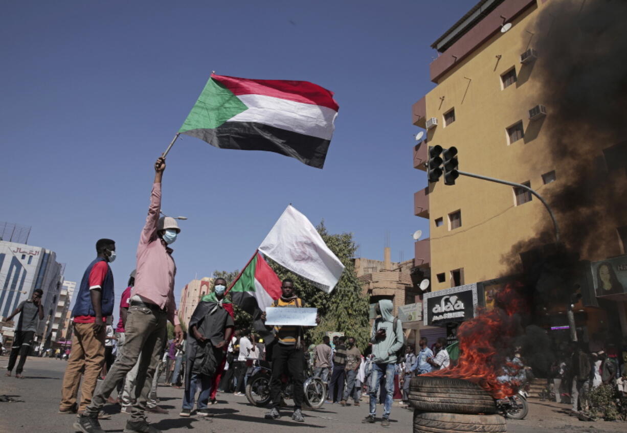 People chant slogans during a protest to denounce the October 2021 military coup, in Khartoum, Sudan, Tuesday, Jan. 4, 2022. Sudanese took to the streets in the capital, Khartoum, and other cities on Tuesday in anti-coup protests as the country plunged further into turmoil following the resignation of the prime minister earlier this week.