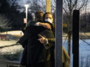 Congregation Beth Israel Rabbi Charlie Cytron-Walker, facing camera, hugs a man after a healing service Monday night at White's Chapel United Methodist Church in Southlake, Texas. Cytron-Walker was one of four people held hostage by a gunman at his Colleyville, Texas, synagogue on Jan. 15.