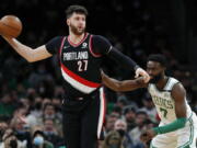 Portland Trail Blazers' Jusuf Nurkic (27) keeps the ball away from Boston Celtics' Jaylen Brown (7) during the first half of an NBA basketball game Friday, Jan. 21, 2022, in Boston.