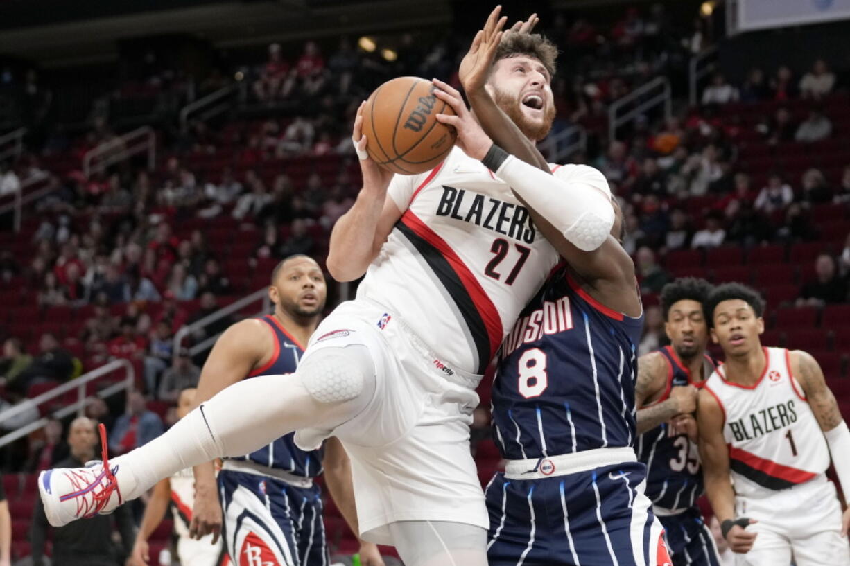 Portland Trail Blazers center Jusuf Nurkic (27) drives to the basket as Houston Rockets forward Jae'Sean Tate (8) defends during the first half of an NBA basketball game, Friday, Jan. 28, 2022, in Houston.