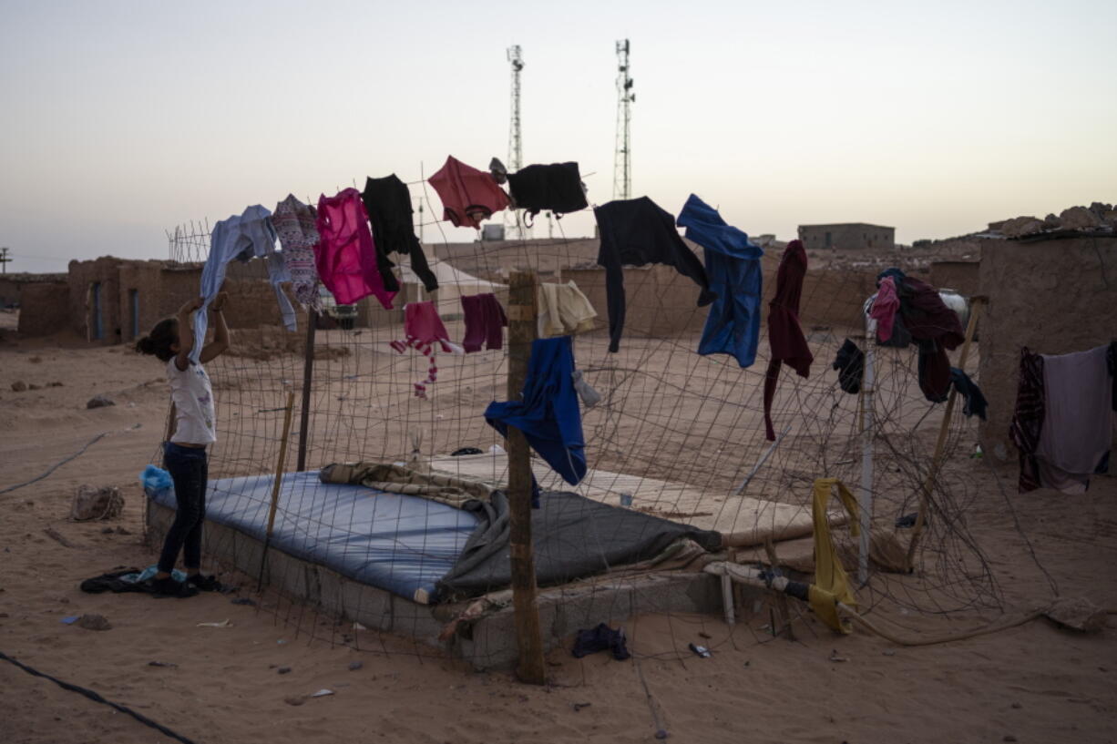 FILE - A Sahrawi refugee girl picks-up the laundry in the Boujdour refugee camp, Algeria, Oct. 15, 2021. The U.N. envoy for the disputed Western Sahara visited refugee camps in Algeria on Saturday Jan. 15, 2022, housing those displaced by fighting decades ago, in a renewed effort to find a diplomatic solution for the territory.