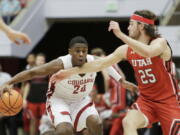 Washington State guard Noah Williams (24) drives the ball while pressured by Utah guard Rollie Worster (25) during the second half of an NCAA college basketball game, Wednesday, Jan. 26, 2022, in Pullman, Wash. Washington State won 71-54.