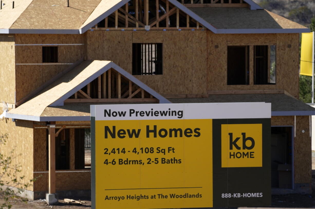 FILE - A sign sits in front of a KB Home construction site, Tuesday, Feb. 2, 2021, in Simi Valley, Calif.  The Biden administration is giving state and local governments greater flexibility in spending $350 billion in federal COVID-19 relief funds. The new rules from the U.S. Treasury Department mean many cities and counties no longer have to prove a revenue loss to spend the money more freely. (AP Photo/Mark J.