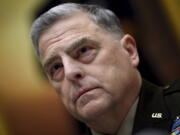 FILE - Gen. Mark Milley, chairman of the Joint Chiefs of Staff, listens during a House Armed Services Committee hearing on the conclusion of military operations in Afghanistan, Sept. 29, 2021, on Capitol Hill in Washington.  Milley has tested positive for COVID-19 and is experiencing very minor symptoms, a spokesperson said Monday.