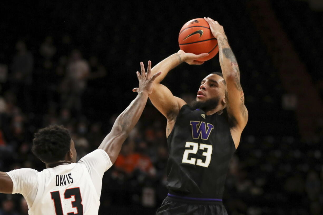 Washington's Terrell Brown Jr. (23) shoots over Oregon State's Dashawn Davis (13) during the first half of an NCAA college basketball game Thursday, Jan. 20, 2022, in Corvallis, Ore.