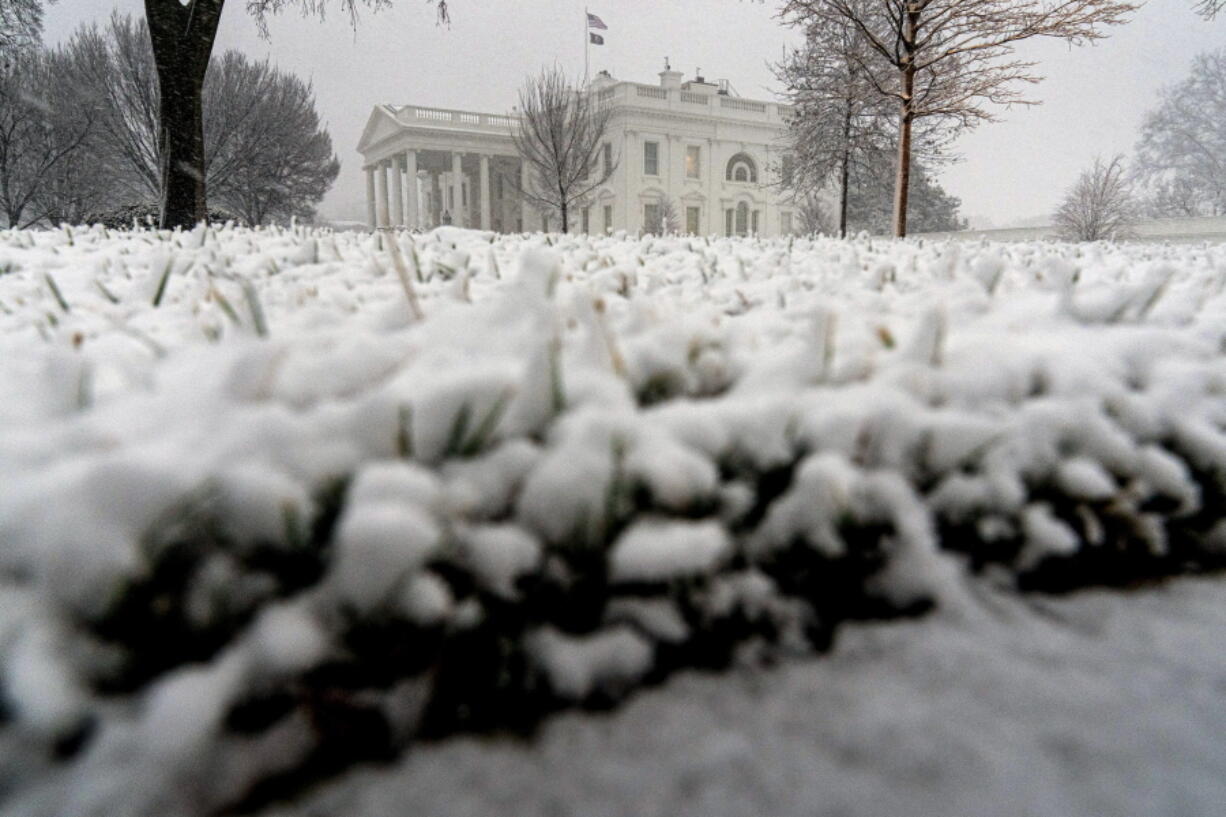 Snow falls at the White House in Washington, Monday, Jan. 3, 2022.