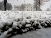 Snow falls at the White House in Washington, Monday, Jan. 3, 2022.