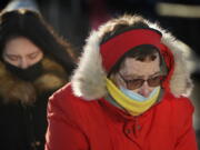 Commuters brave frigid temperatures as they arrive on a ferry, Tuesday, Jan. 11, 2022, in Portland, Maine. Parts of the Northeast are expected to have a wind chill of minus 40 degrees Fahrenheit. (AP Photo/Robert F.