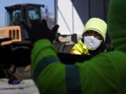 A Georgia Department of Transportation response member looks at a brine truck tank being filled ahead of a winter storm at the GDOT's Maintenance Activities Unit location on Friday, Jan. 14, 2022, in Forest Park, Ga. A winter storm is headed south that could effect much of Georgia through Sunday.