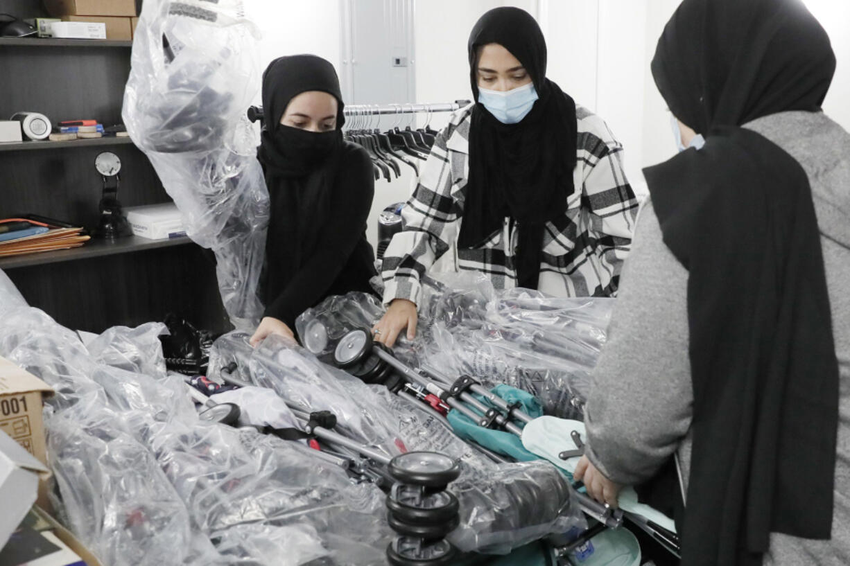 Volunteers sort new donated baby strollers Nov. 14 at the Imam Ali Masjid mosque in Pennsauken, N.J.