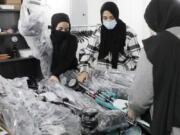 Volunteers sort new donated baby strollers Nov. 14 at the Imam Ali Masjid mosque in Pennsauken, N.J.