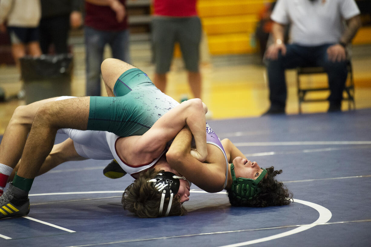 Prairie's Mason Frei (bottom) wrestles Heritage's Quincy Lopez in the 152-pound final at the 3A district wrestling tournament at Prairie on Saturday, Feb. 5, 2022.