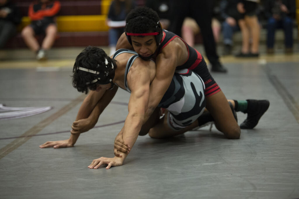 Camas' Devin Padilla wrestles Union's Armando Nicacio in the 138-pound final at the 4A district wrestling tournament at Prairie on Saturday, Feb. 5, 2022.