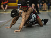 Camas' Devin Padilla wrestles Union's Armando Nicacio in the 138-pound final at the 4A district wrestling tournament at Prairie on Saturday, Feb. 5, 2022.