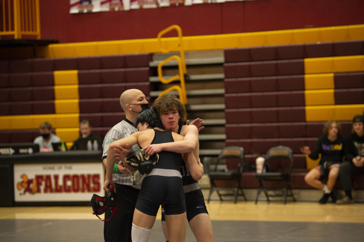 Union's Spencer Needham hugs teammate Jordin Jimenez after winning the 126-pound title at the 4A district wrestling tournament at Prairie on Saturday, Feb. 5, 2022.