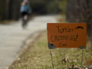 Concerned residents posted handmade signs warning drivers to slow down for turtles. Road crossings are often fatal for turtles.